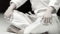 A girl in a kimono kneads before training in judo and jujitsu