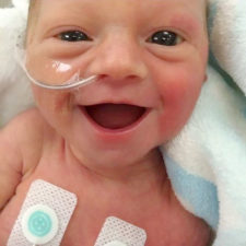 Smiling five days old premature baby girl photo lauren vinje 2.jpg