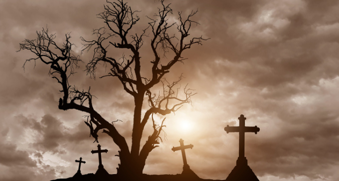 Halloween concept with scary silhouette dead tree and spooky crosses