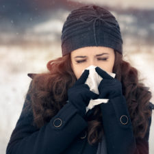 Woman with Tissue Outside Feeling Bad Cold Winter