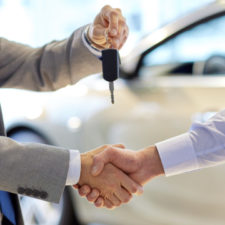 Close up of handshake in auto show or salon