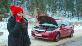 Woman Calling For Help With Broken Down Car At Winter Highway