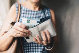 Closeup photo of stylish woman taking money out the wallet