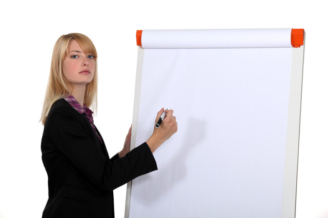 Blond businesswoman about to write on white-board
