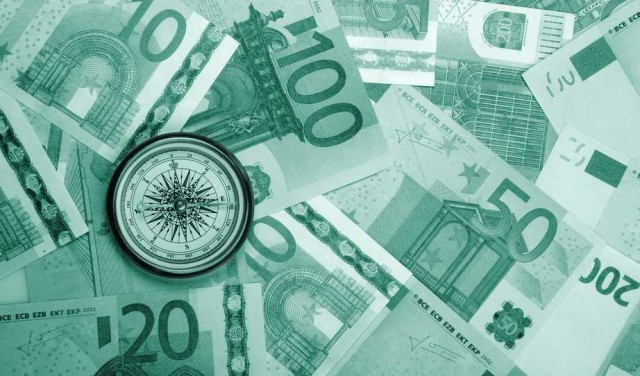 Kompas položený na eurobankovkách