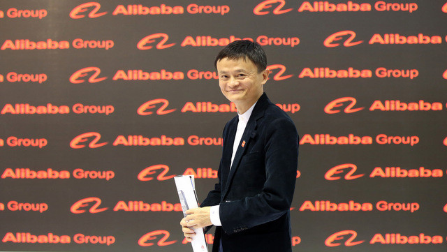 Jack Ma, founder and CEO of the Alibaba Group walks through the Chinese pavilion on the opening day of the Cebit 2015 tech fair in Hannover, northern Germany, Monday, March 16, 2015. China is this year's official partner country. (AP Photo/dpa, Christian Charisius)