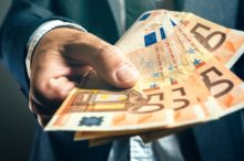 Businessman from bank offering money loan in euro banknotes