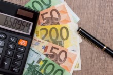 Euro, calculator and pen on desk