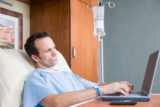 Hospital patient with laptop and smartphone