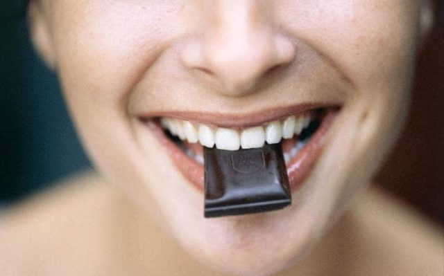 Woman eating dark chocolate large.jpg