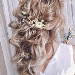 Wedding hairstyles 2019 curly half up half down on blonde hair with flowers in bohemian style my_wedmakeup 334x500.jpg