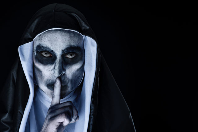 Frightening evil nun asking for silence