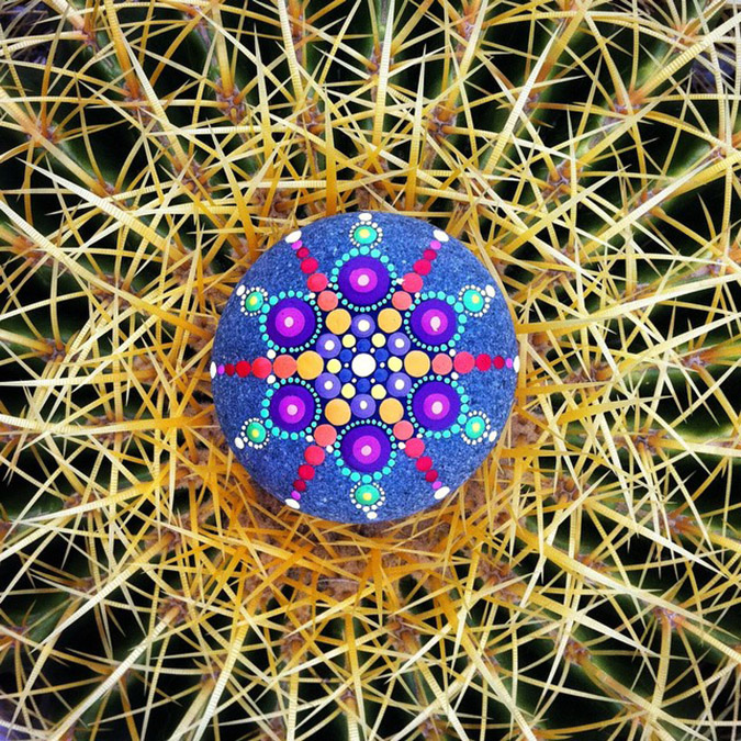 Mandala stones placed atop cactus.jpeg