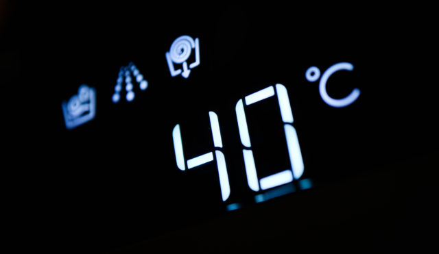 Washing machine panel display, setting 40 degrees temperature. Abstract laundry programming.