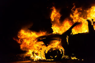 Car in fire, burning at night