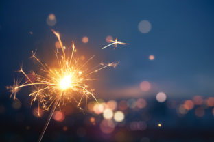 Sparkler with blurred busy city light background