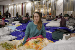 Russia Ukraine Anna Karpenko, 32 years old, who fled the Russian invasion from Chornomorsk with her son and mother, poses for a portrait inside a ballroom converted into a makeshift refugee shelter at a 4 star hotel &amp; spa, in Suceava, Romania, Friday, March 4, 2022. At 4 star hotel &amp; spa some 50 km from the border with Ukraine, wedding parties and conferences have been canceled and the ballroom converted into a makeshift refugee shelter where those who have escaped the Russian invasion come to rest and warm up before continuing their journey. War Romania Shelter