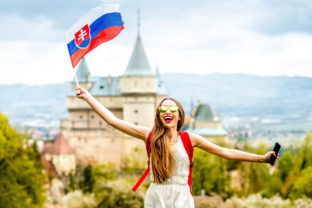 Woman with slovak flag near the castle