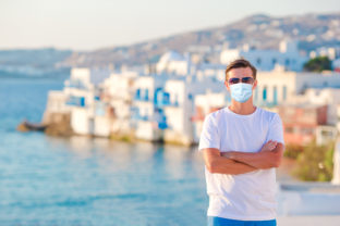 Tourist man in mask on vacation in Europe.