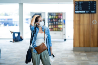 COVID 19 worldwide borders closures.Traveler with face mask stuck in airport terminal after being denied entry to other countries. Passenger stranded in airport on his travel back to home country.