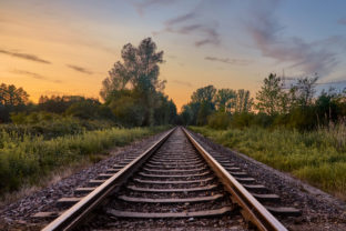 Train tracks infront of beautiful nature and the sunset in Rastatt, Germany