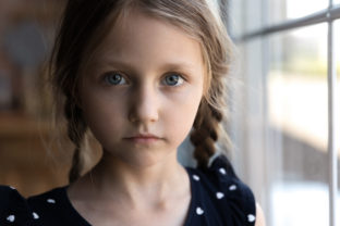 Close up portrait of Caucasian sad little girl