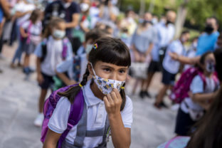 A girl wearing a face mask to protect against the spread of coronavirus arrives at Maestro Padilla school as the new school year begins, in Madrid, Spain, Tuesday, Sept. 7, 2021. Around 8 million children in Spain are set to start the new school year. (AP Photo/Manu Fernandez)