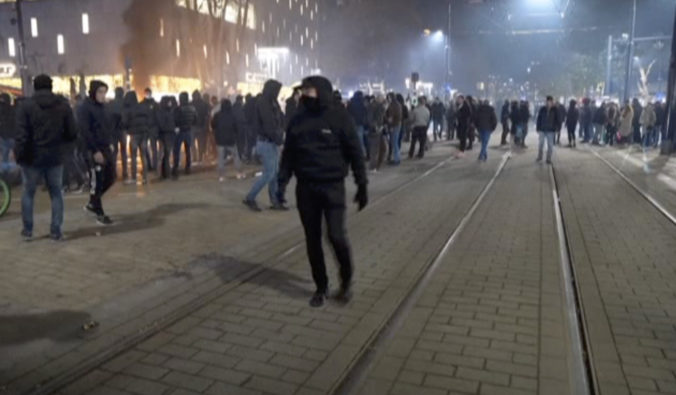 Virus Outbreak Netherlands In this image taken from video, demonstrators protest against government restrictions due to the coronavirus pandemic, Friday, Nov. 19, 2021, in Rotterdam, Netherlands. Police fired warning shots, injuring an unknown number of people, as riots broke out Friday night in downtown Rotterdam at a demonstration against plans by the government to restrict access for unvaccinated people to some venues.