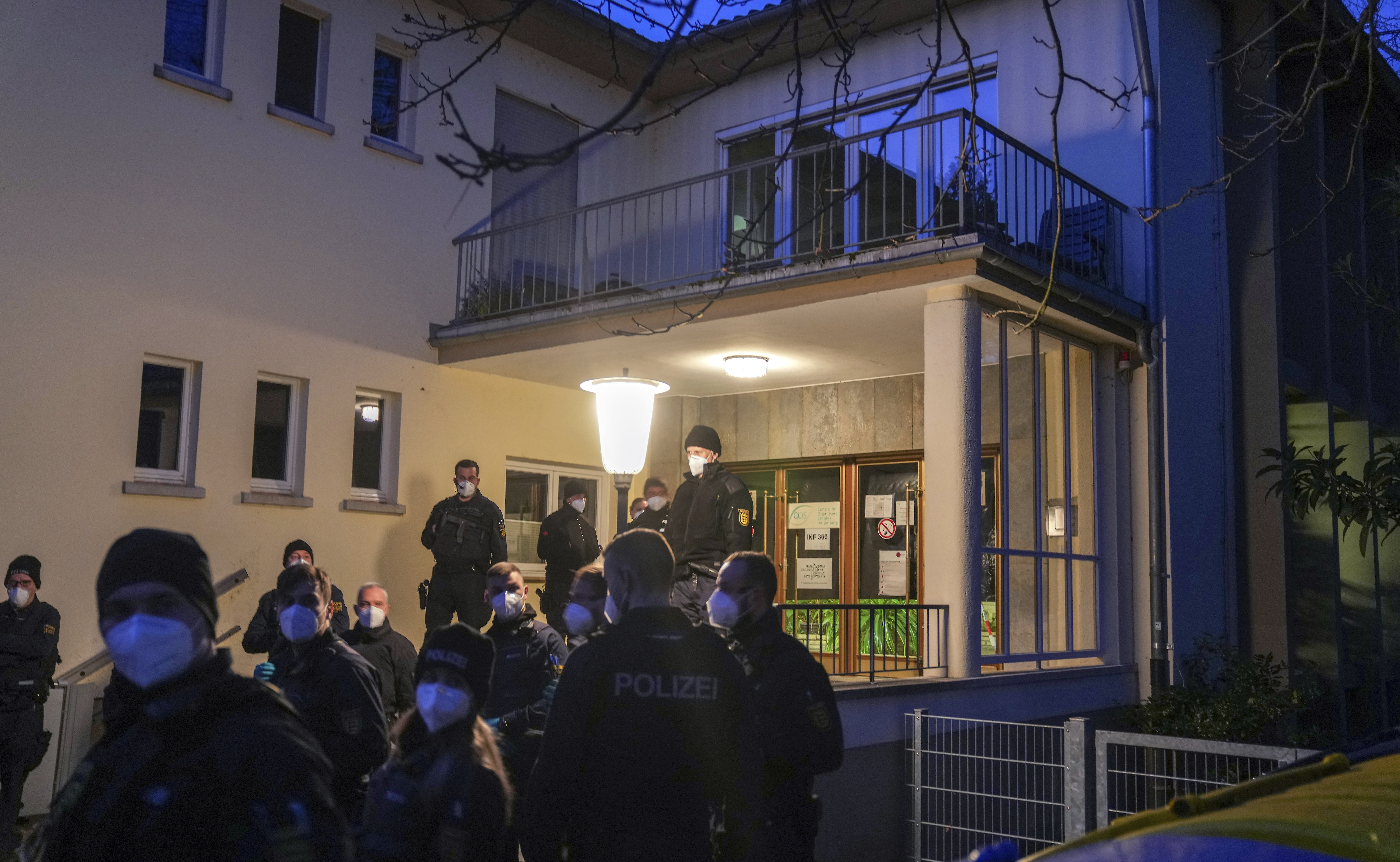Germany Shooting Police officers stay in front of the crime scene on the grounds of the Heidelberg University in Heidelberg, Germany, Monday, Jan. 24, 2022. German police say a lone gunman wounded several people at a lecture theatre in the southwest city of Heidelberg on Monday. Police said in a brief statement that the perpetrator was dead but didn't give details of how that happened.