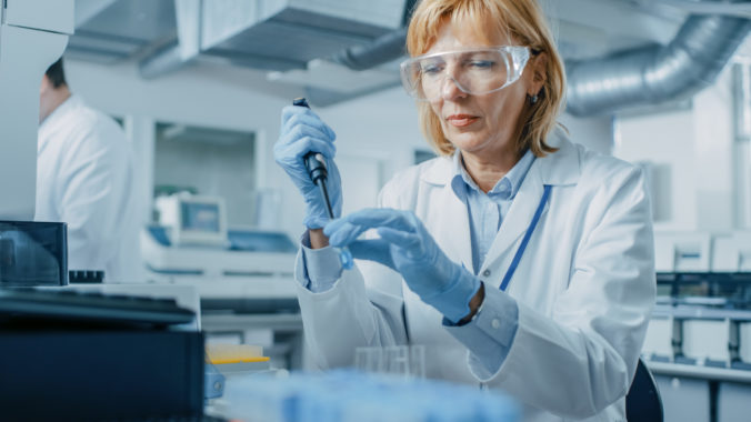 Female Research Scientist Uses Micro Pipette while Working with Test Tubes. People in Innovative Pharmaceutical Laboratory with Modern Medical Equipment for Genetics Research.