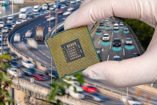The computer circuit board and fast moving cars. A hand holding a CPU chipset.