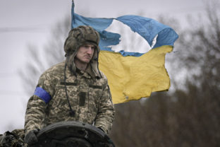 APTOPIX A Ukrainian serviceman is backdropped by his country's flag while standing on a tank, outside Kyiv, Ukraine, Saturday, April 2, 2022. As Russian forces pull back from Ukraine's capital region, retreating troops are creating a "catastrophic" situation for civilians by leaving mines around homes, abandoned equipment and "even the bodies of those killed," President Volodymyr Zelenskyy warned Saturday Russia Ukraine War