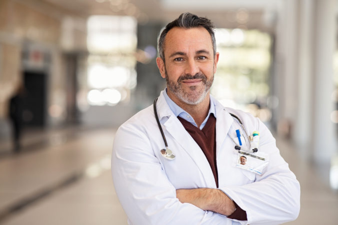 Confident successful mature doctor at hospital