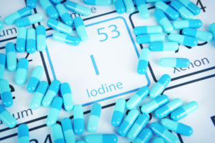 Iodine - Mineral Supplement on Periodic Table Iodine with capsules or pills on the periodic table (Periodic table made by me)  Stock image representing mineral supplementation.