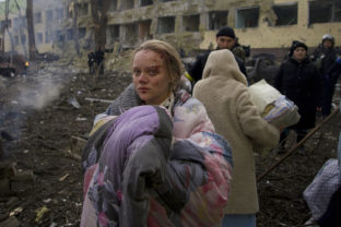 Russia Ukraine War Blogger stands outside a maternity hospital that was damaged by shelling in Mariupol, Ukraine, Wednesday, March 9, 2022. Vishegirskaya, a Ukrainian beauty blogger who Russian officials accused of being a crisis actor when she was photographed in the rubble of a Mariupol maternity hospital a month earlier, has emerged in new videos that are fueling fresh misinformation about the attack.