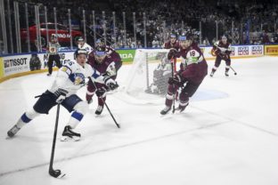 Toni Rajala of Finland, Finland Hockey World Championships left, and Karlis Cukste and Rodrigo Abols of Latvia in action during the 2022 IIHF Ice Hockey World Championships preliminary round group B match between Latvia and Finland in Tampere, Finland,