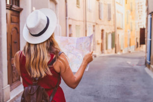Travel to Europe, tourist looking at map on the street, summer holidays