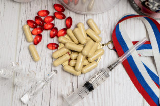 Tablets, pills and syringe of doping drugs or medicine with russ