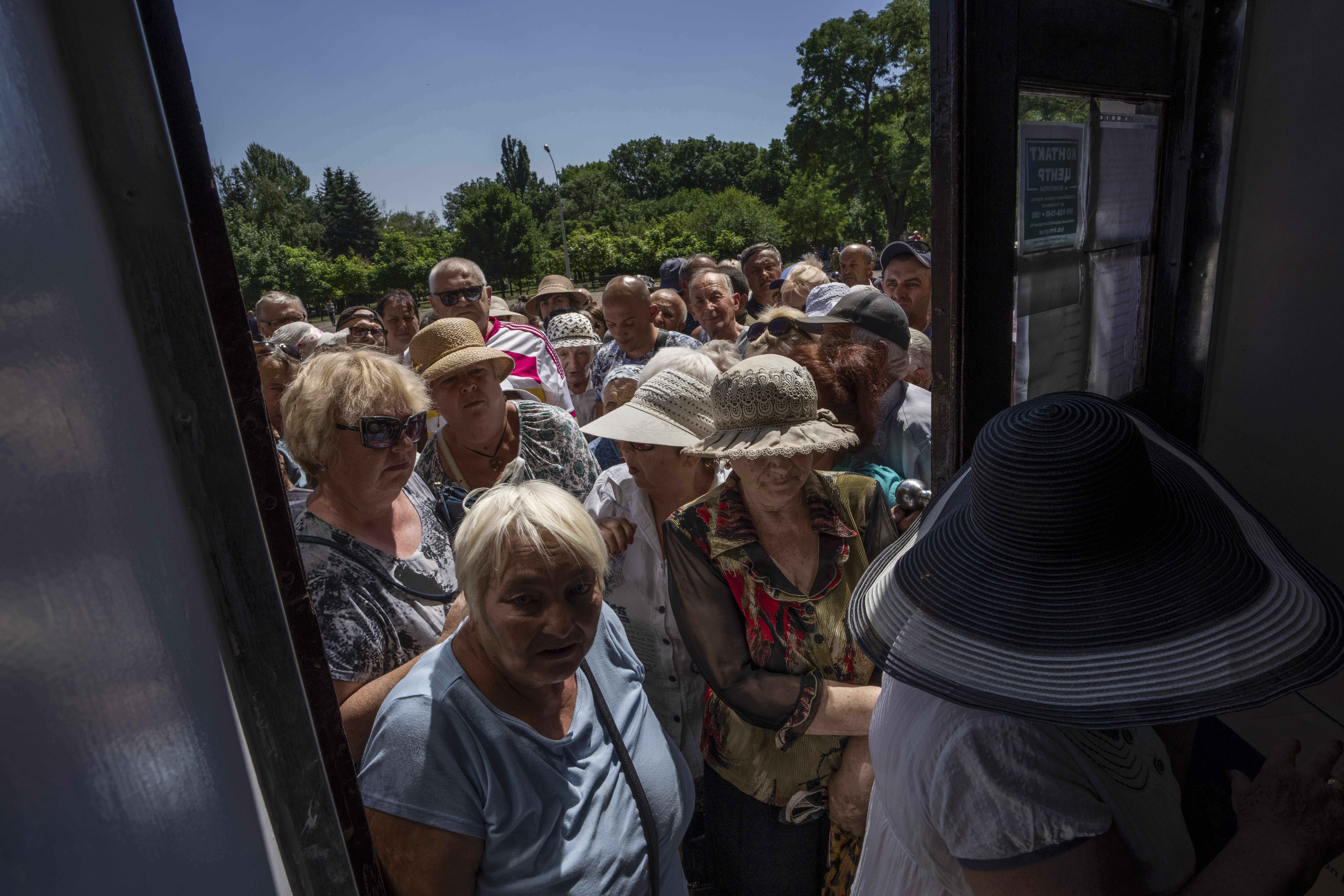 People wait in line to receive humanitarian food aid from the Kramatorsk city council, eastern Ukraine
