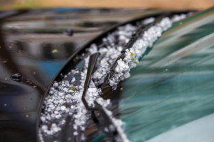 Small Hail Ice Balls On Black Car Hood After Heavy Summer Storm