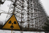 Russia Ukraine War Nuclear Fear FILE - A Soviet era top secret object Duga, an over the horizon radar system once used as part of the Soviet missile defense early warning radar network, seen behind a radioactivity sign in Chernobyl, Ukraine, on Nov. 22, 2018. Russia’s attack on a nuclear power plant in Ukraine has revived the fears of people across Europe who remember the 1986 Chernobyl disaster
