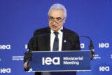 FILE - IEA Executive Director Fatih Birol delivers his speech at the opening session of the International Energy Agency (IEA) ministerial meeting, March 23, 2022 in Paris. Birol and Ukraine's Minister of Energy German Galushchenko have signed today, Tuesday, July 19, 2022, in Warsaw, Poland, the documents for Ukraine to become an Association country of the International Energy Agency, with both sides agreeing that a closer cooperation will help Europe to face what they expect to be a hard winter for the energy sector due to Russia’s aggressive policy.