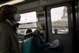 Virus Outbreak France Commuters wears face mask to protect against COVID 19 in a metro, in Paris, France, Thursday, Dec. 30, 2021. Residents and tourists in Paris will be required to wear the mask outdoors starting from Friday, amid a surge of COVID 19 infections in the country fueled by the omicron variant.